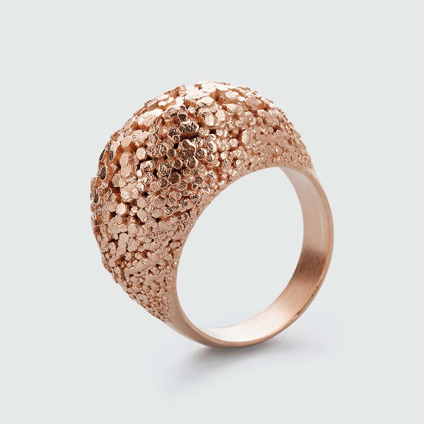 Rosegold crystal ring with surface structure.