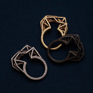 3D printed steel ring with gold and bronze variants.