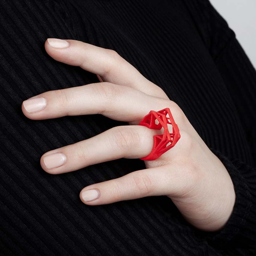 Coral red big statement ring with woman.
