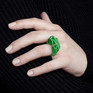 Woman with an abstract green big statement ring.