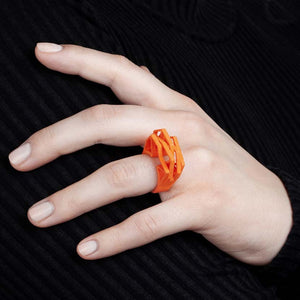 Lady wearing an orange big statement ring.