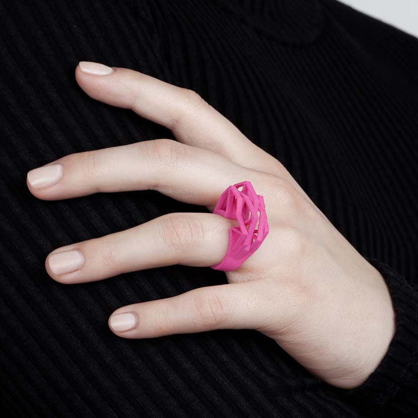Big statement ring in pink worn by lady.