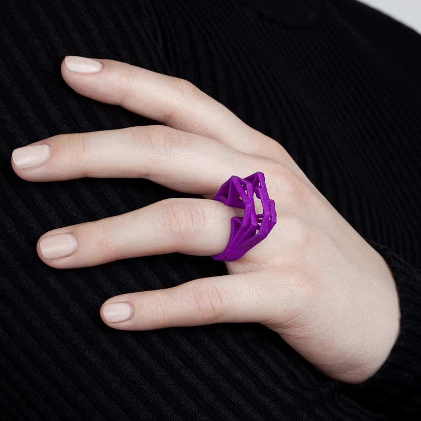 Woman shows a purple big statement ring.