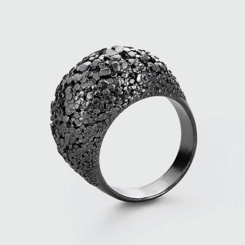 Black crystal ring with detailed surface.