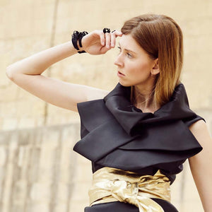 Two black cuff bracelets and black ring on hand during Malta Fashion week.