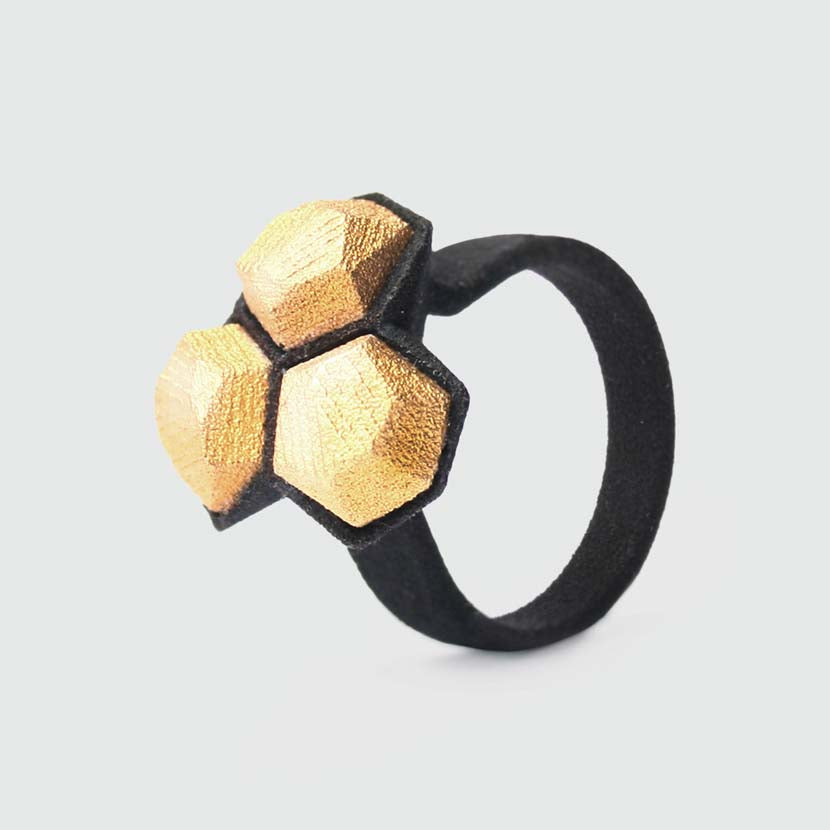 Black gold ring made from 3d printed materials.