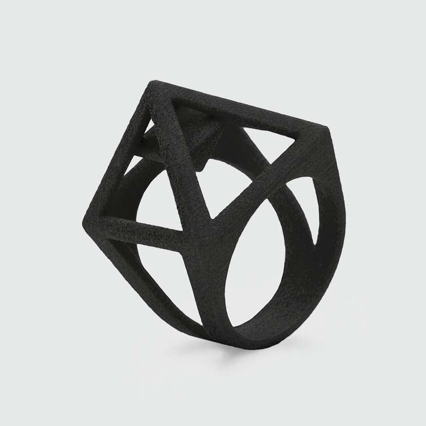 Black pyramid ring made of 3D printed nylon.