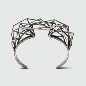 Cuff bracelet steel with intricate structure.