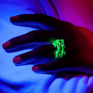 Neon green cyberpunk jewelry displayed under black light.