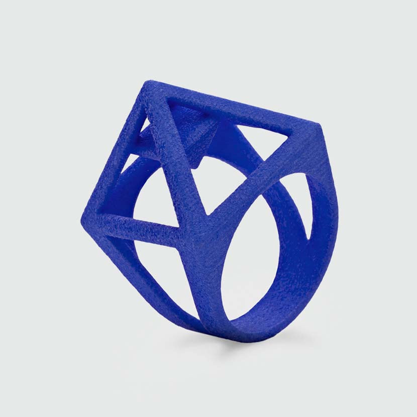 Designer ring with a blue pyramid.