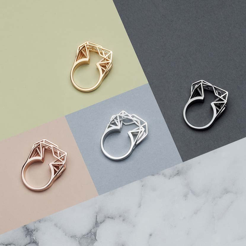Geometric statement rings in gold, rose gold, black rhodium and silver.
