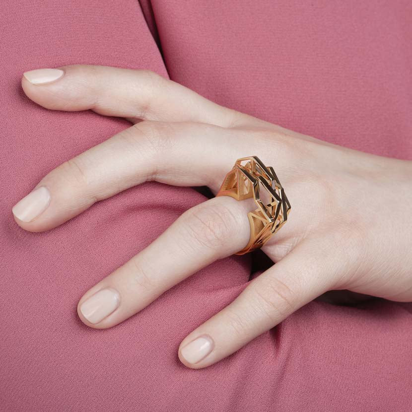 Geometric statement ring shown by hand model.