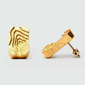 Gold architectural earrings with gold studs.