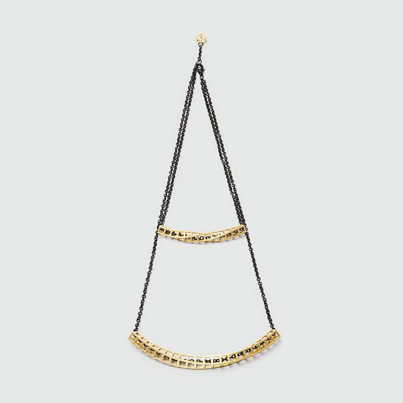Gold double necklace with black chain.