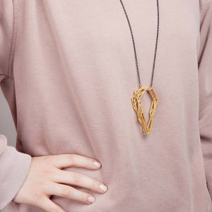 Gold geometric pendant with rose jumper.