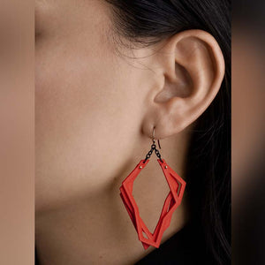 Red lightweight statement earrings with abstract shape.