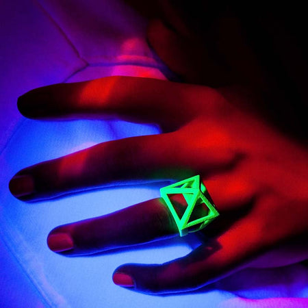 Neon jewelry is shown by hand model.
