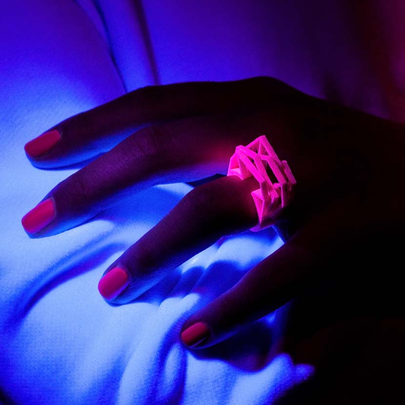 Intense neon pink ring under black light.