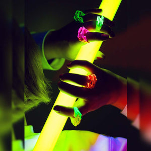 Woman with neon yellow rings holding a light sword.