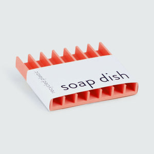 Red soap dish with branding.