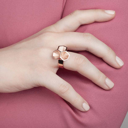 Rose gold honeycomb ring shown by model.