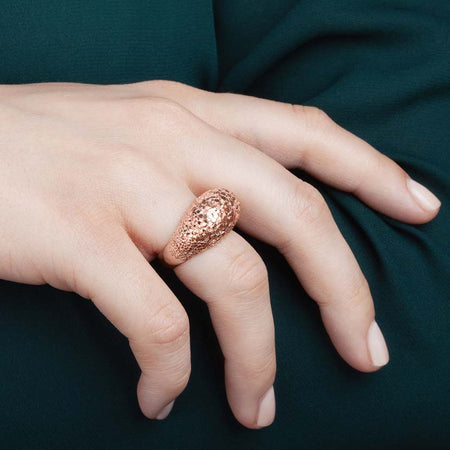 Rosegold crystal ring on model's finger.