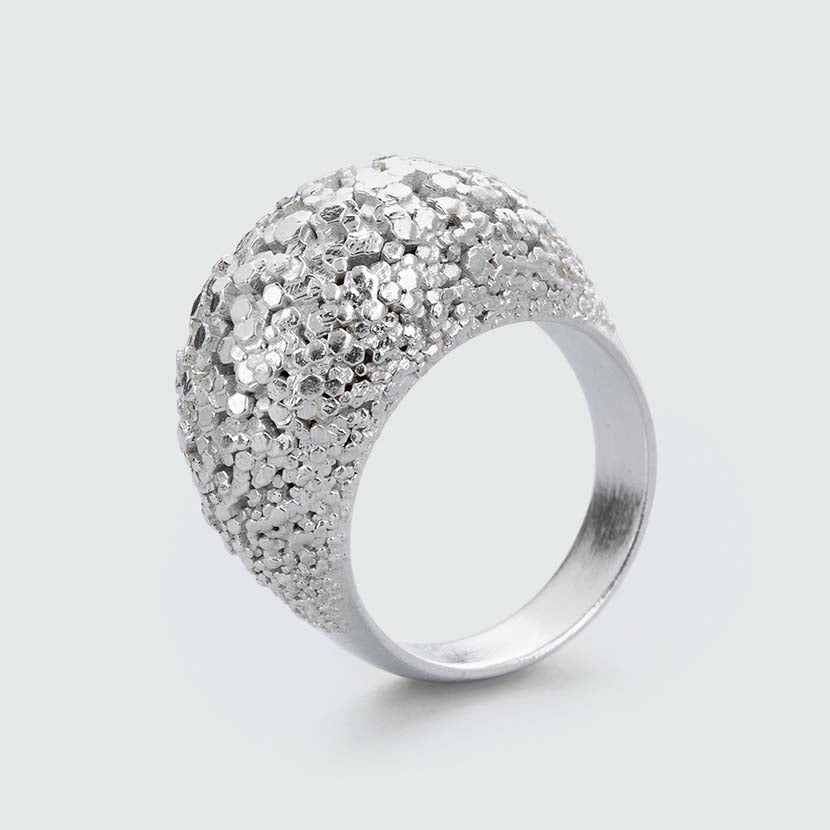 Silver dome ring with uncountable facets.
