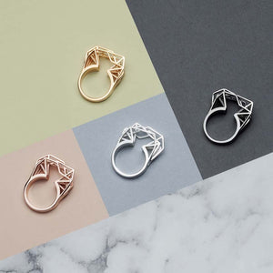 Silver geometric ring with a gold, a rose gold and a black ring.