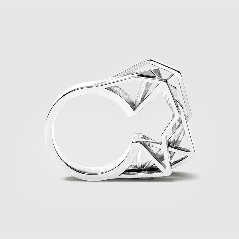 Silver geometric ring with shiny facets.