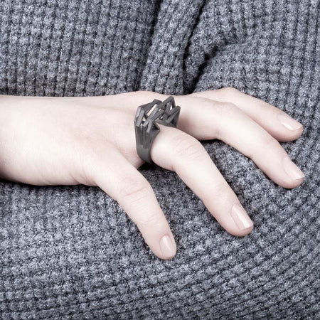 Statement ring titanium displayed by woman.